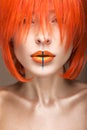 Beautiful girl in an orange wig cosplay style with bright creative lips. Art beauty image. Royalty Free Stock Photo