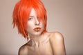 Beautiful girl in an orange wig cosplay style with bright creative lips. Art beauty image.