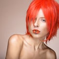 Beautiful girl in an orange wig cosplay style with bright creative lips. Art beauty image. Royalty Free Stock Photo