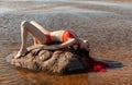 Girl in a red bathing suit on the beach Royalty Free Stock Photo