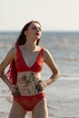 Girl in a red bathing suit on the beach Royalty Free Stock Photo