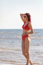 Girl in a red bathing suit on the beach Royalty Free Stock Photo