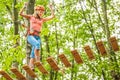 Beautiful girl in the park on the ropes achieve Outdoors Royalty Free Stock Photo