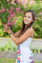 Beautiful girl in the park under the lilac tree.