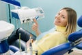 Beautiful girl patient shows the class with her hand while sitting in the Dentist& x27;s chair Royalty Free Stock Photo