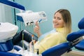 Beautiful girl patient shows the class with her hand while sitting in the Dentist& x27;s chair Royalty Free Stock Photo