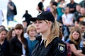 A beautiful girl patrol police officer is standing on street. Policewoman in uniform, chevron and sign of Ukrainian police in Royalty Free Stock Photo