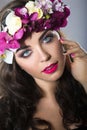 Beautiful girl with perfect skin and bright floral wreath on her head.