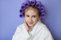 A beautiful girl with perfect skin and hair wrapped in curlers Royalty Free Stock Photo