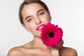 Beautiful girl with perfect skin holding gerbera flower Royalty Free Stock Photo