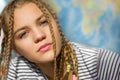 Beautiful girl with pigtails close-up on a background of a physical world map Royalty Free Stock Photo