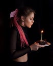 A beautiful girl with pink afro or zizi pigtails with a birthday cake on a black Royalty Free Stock Photo