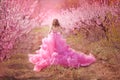 Beautiful girl in a pink dress in peach garden Royalty Free Stock Photo