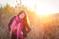 Beautiful girl with pink scarf at sunset in a field. Portrait at sunset, yellow light, beautiful background Royalty Free Stock Photo