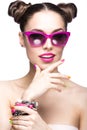 Beautiful girl in pink sunglasses with bright makeup and colorful nails. Beauty face.