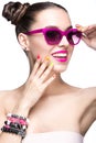 Beautiful girl in pink sunglasses with bright makeup and colorful nails. Beauty face. Royalty Free Stock Photo