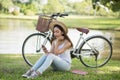 Beautiful girl play smartphone in park Royalty Free Stock Photo