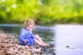 Beautiful girl playing at river shore Royalty Free Stock Photo