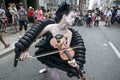 Beautiful girl playing the violin. Female violinist perform in a street festival
