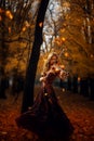 Beautiful girl plays the violin in an red autumn park with flying leaves. Fantasy. AI generative