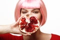 Girl with pomegranate. Pink hair