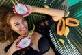 Beautiful girl in pool at hotel. Black swimsuit near tropical fruit papaya ,dragonfruit, pineapple, banana, summer vacation,