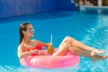 Beautiful girl in the pool on inflatable lifebuoy Royalty Free Stock Photo