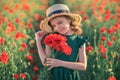 beautiful girl in poppy field enjoys the beauty and aromas.