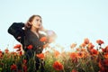 Beautiful Girl in poppy field. Woman on flowering poppy field Royalty Free Stock Photo
