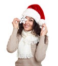 Beautiful girl portrait dressed in santa hat show big snowflake toy. White isolated background. New year eve and winter holiday co Royalty Free Stock Photo