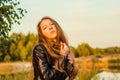 Beautiful girl in a posh red dress posing on a poppy field. Poppy field at sunset. Art processing. Sunset Royalty Free Stock Photo