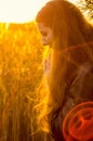 Beautiful girl in a posh red dress posing on a poppy field. Poppy field at sunset. Art processing. Sunset Royalty Free Stock Photo