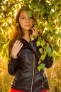 Beautiful girl in a posh red dress posing on a poppy field. Poppy field at sunset. Art processing. Sunset Royalty Free Stock Photo