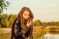 Beautiful girl in a posh red dress posing on a poppy field. Poppy field at sunset. Art processing. Sunset Royalty Free Stock Photo