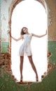 Beautiful girl posing fashion in a window frame Royalty Free Stock Photo