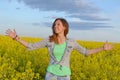 Beautiful girl posing in a field of yellow flowers Royalty Free Stock Photo