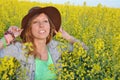 Beautiful girl posing in a field of yellow flowers Royalty Free Stock Photo