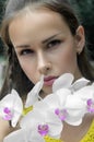 Beautiful girl posing with orchid flower Royalty Free Stock Photo