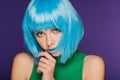 Beautiful girl posing in trendy blue wig, isolated