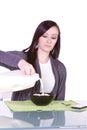 Beautiful Girl Pouring Milk to her Cereal