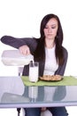 Beautiful Girl Pouring Milk to her Glass Royalty Free Stock Photo