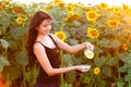 Beautiful girl pours sunflower oil from the pitcher Royalty Free Stock Photo