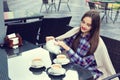 Beautiful girl pours tea from teapot into a cups