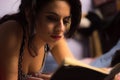 Beautiful girl with professional make-up reading a book Royalty Free Stock Photo