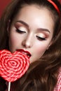 Beautiful girl with professional makeup and big candy Royalty Free Stock Photo