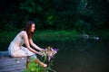 Beautiful girl puts a wreath in river Royalty Free Stock Photo