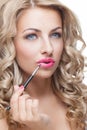 Beautiful girl putting lipstick on Royalty Free Stock Photo