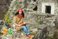 Beautiful girl read book near old castle. Autumn time. Royalty Free Stock Photo