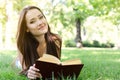 Beautiful girl reading book in the summer park. Young woman with book, summer outdoor Royalty Free Stock Photo