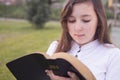 Beautiful girl reading holy bible